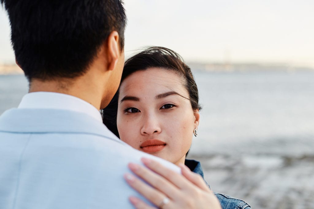 A couple pose for a romantic photo as part of a professional photoshoot in Lisbon