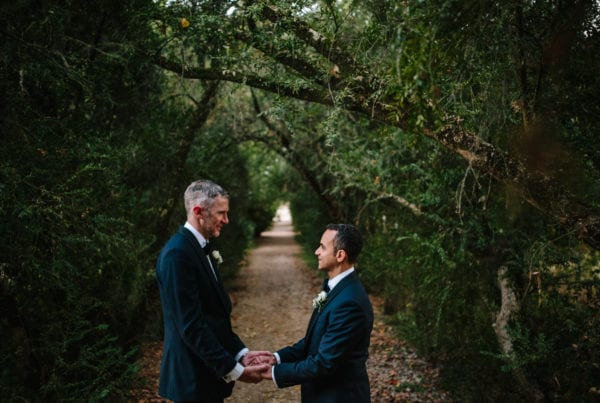Gay couple holding hands on their wedding day in Portugal