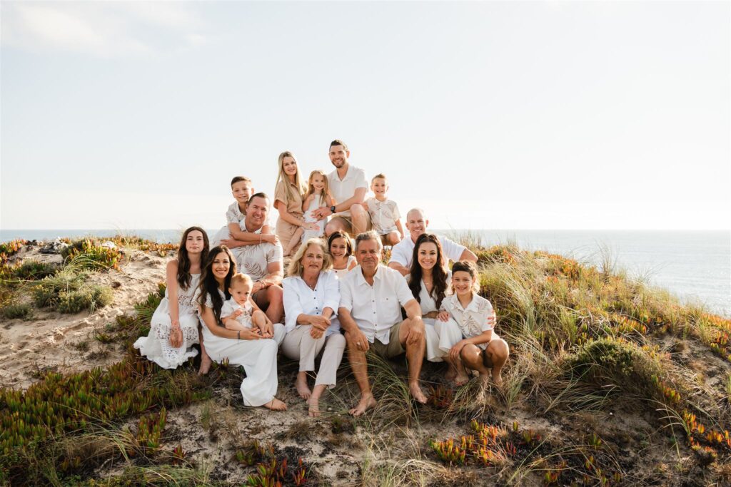 Extended family photoshoot on the beach in Portugal an extended family posing for a photo on the beach in Portugal